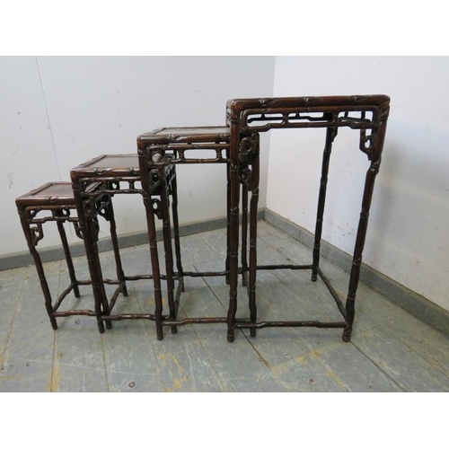 710 - A set of four antique Chinese hardwood nesting tables, having carved and pierced frieze modelled as ... 