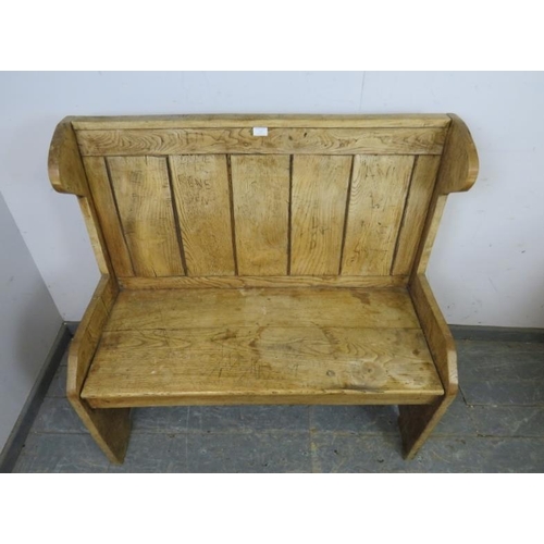 715 - An antique elm settle of small proportions, the panelled back above a planked seat, on stile support... 