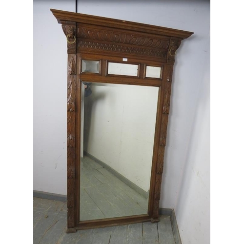 719 - A large 19th century dressing mirror, the sectioned and bevelled plates within a carved oak surround... 