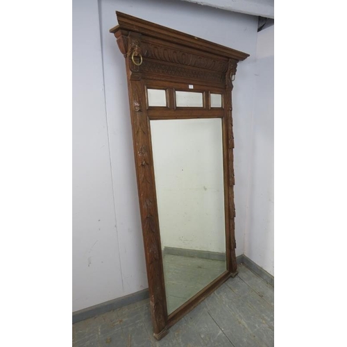 719 - A large 19th century dressing mirror, the sectioned and bevelled plates within a carved oak surround... 