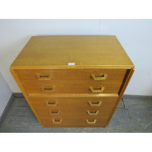 726 - A mid-century light oak G-Plan ‘Brandon’ chest, housing five long graduated drawers, on a plinth bas... 