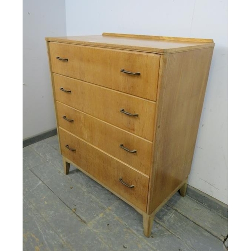 728 - A mid-century light oak reverse breakfront chest of four long drawers with brass handles, on tapered... 