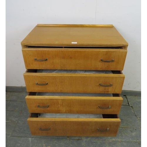 728 - A mid-century light oak reverse breakfront chest of four long drawers with brass handles, on tapered... 