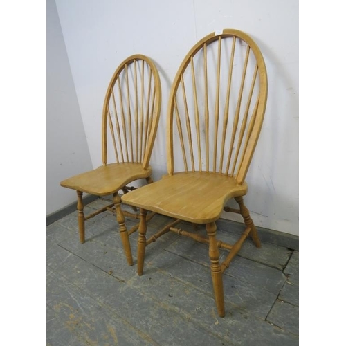 729 - A pair of contemporary high-back beech Windsor chairs, the shaped seats on canted turned supports jo... 