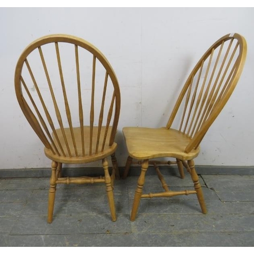 729 - A pair of contemporary high-back beech Windsor chairs, the shaped seats on canted turned supports jo... 