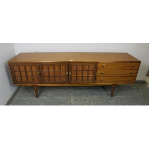 731 - A mid-century teak sideboard by Younger, housing three cupboards with loose shelf, and three short d... 