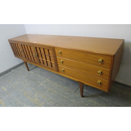 731 - A mid-century teak sideboard by Younger, housing three cupboards with loose shelf, and three short d... 