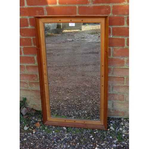 737 - A vintage rectangular wall mirror within a moulded walnut and beech surround with applied ball decor... 