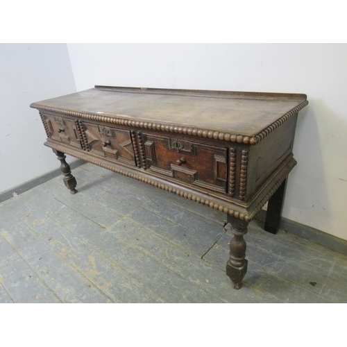 749 - A 17th century Charles II and later oak dresser base, housing three short drawers with block geometr... 