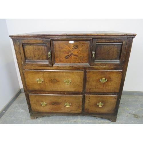 750 - A late 17th/early 18th century oak chest, housing two small cupboards with marquetry inlaid central ... 