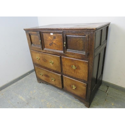 750 - A late 17th/early 18th century oak chest, housing two small cupboards with marquetry inlaid central ... 