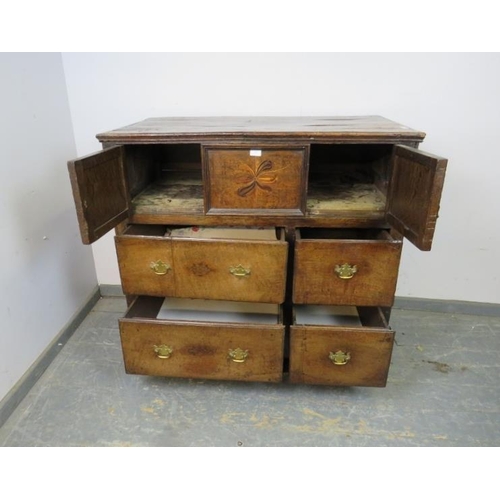 750 - A late 17th/early 18th century oak chest, housing two small cupboards with marquetry inlaid central ... 