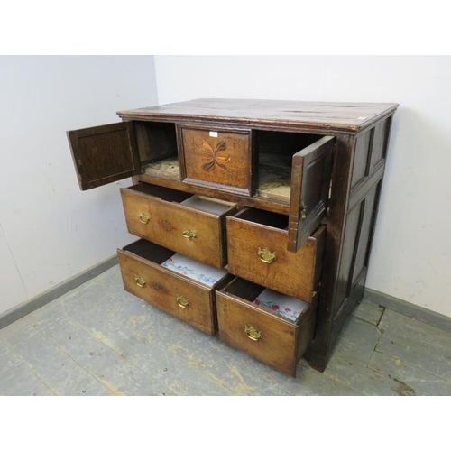 750 - A late 17th/early 18th century oak chest, housing two small cupboards with marquetry inlaid central ... 