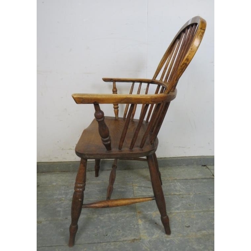 751 - A 19th century elm hoop-back Windsor chair, on turned supports joined with a turned ‘H’ stretcher. 
... 