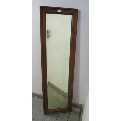 754 - An antique rectangular bevelled dressing mirror, within a moulded pitch pine surround. 
H138 x W41 x... 