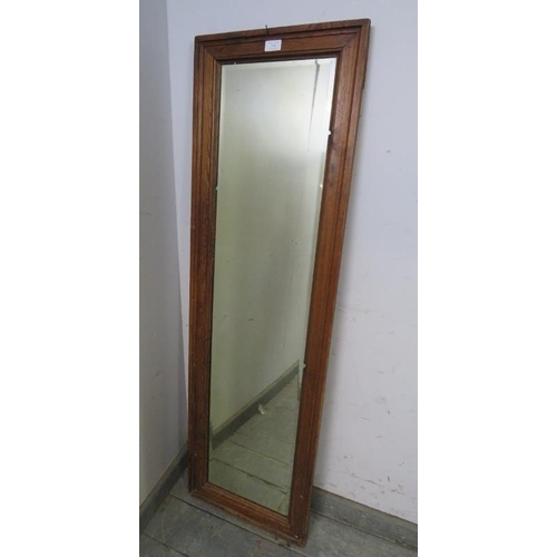 754 - An antique rectangular bevelled dressing mirror, within a moulded pitch pine surround. 
H138 x W41 x... 