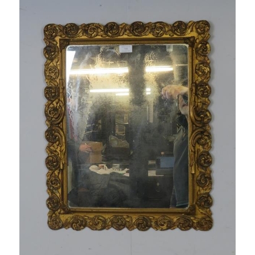 759 - An antique style rectangular wall mirror, within a gilt gesso surround modelled as scrolling acanthu... 