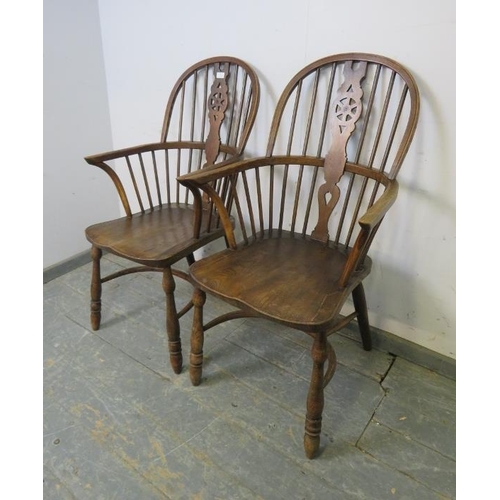 765 - A pair of antique elm and oak Windsor wheelback armchairs, on turned supports joined with crinoline ... 