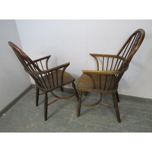 765 - A pair of antique elm and oak Windsor wheelback armchairs, on turned supports joined with crinoline ... 