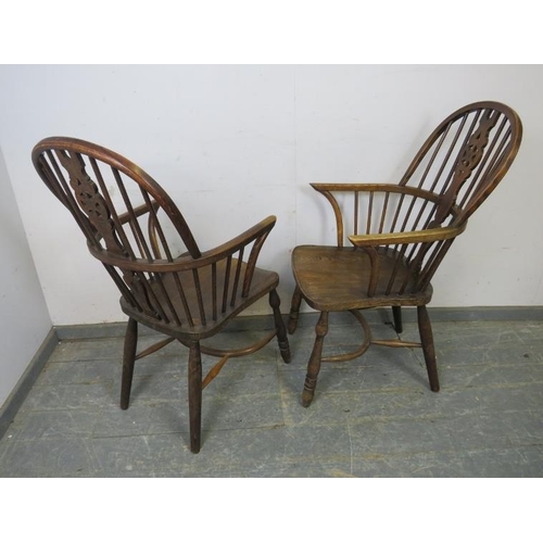 765 - A pair of antique elm and oak Windsor wheelback armchairs, on turned supports joined with crinoline ... 