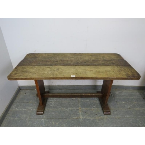 769 - An Arts & Crafts Period oak refectory table of small proportions, the planked top on stile end suppo... 