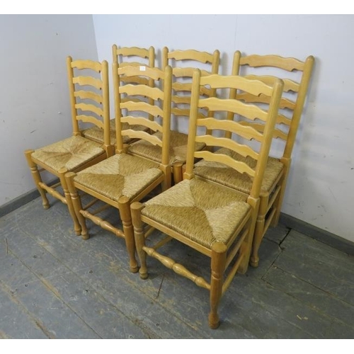 770 - A set of six antique style ash Lancashire ladderback dining chairs, with rush seats, on turned front... 