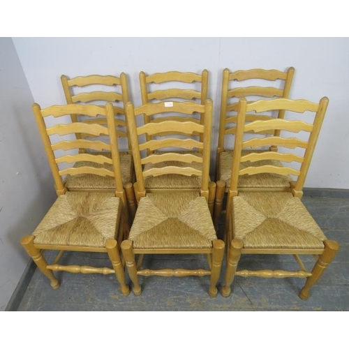 770 - A set of six antique style ash Lancashire ladderback dining chairs, with rush seats, on turned front... 