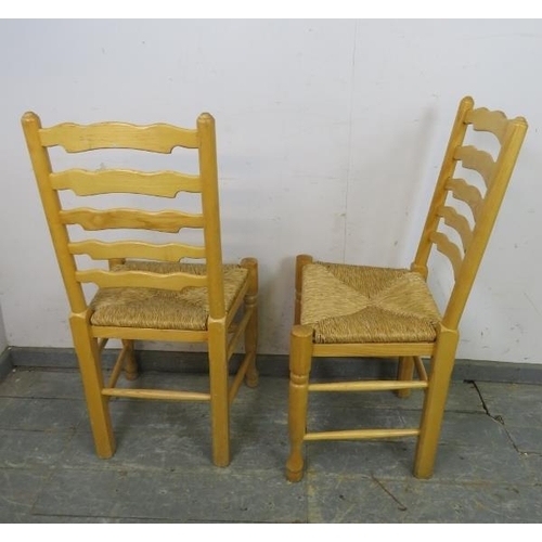 770 - A set of six antique style ash Lancashire ladderback dining chairs, with rush seats, on turned front... 