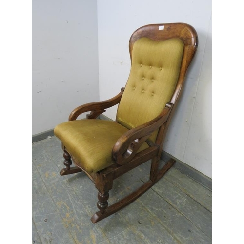 775 - A Victorian walnut rocking chair, re-covered in buttoned tan material, on turned supports with rocke... 