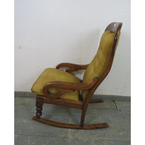 775 - A Victorian walnut rocking chair, re-covered in buttoned tan material, on turned supports with rocke... 