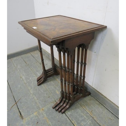 783 - A set of four Edwardian mahogany and rosewood nesting tables, the tops with inlaid flame mahogany pa... 