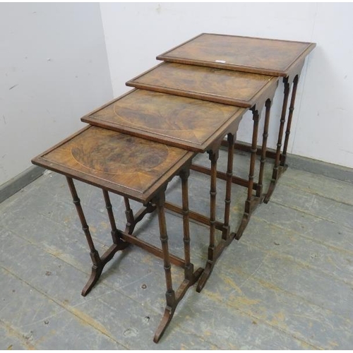 783 - A set of four Edwardian mahogany and rosewood nesting tables, the tops with inlaid flame mahogany pa... 