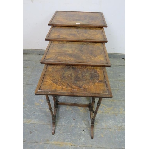 783 - A set of four Edwardian mahogany and rosewood nesting tables, the tops with inlaid flame mahogany pa... 