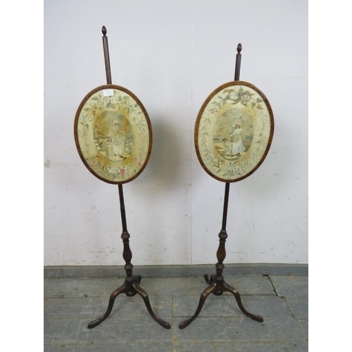 784 - A pair of 19th century mahogany pole screens, having acorn finials and brass fittings, with inset si... 