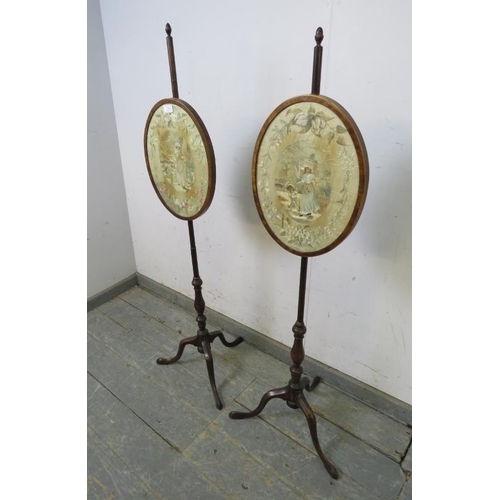 784 - A pair of 19th century mahogany pole screens, having acorn finials and brass fittings, with inset si... 