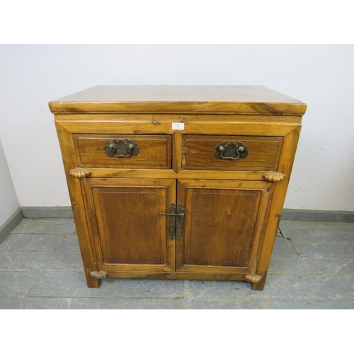 789 - A vintage Chinese hardwood side cabinet, housing two short drawers above twin doors opening onto a l... 