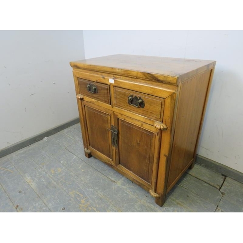 789 - A vintage Chinese hardwood side cabinet, housing two short drawers above twin doors opening onto a l... 