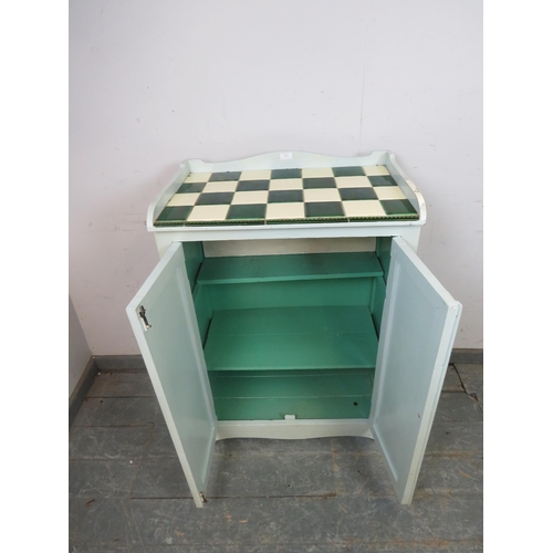 795 - An antique pine cabinet painted grey, the top with ¾ gallery and inset green and cream tiles, above ... 