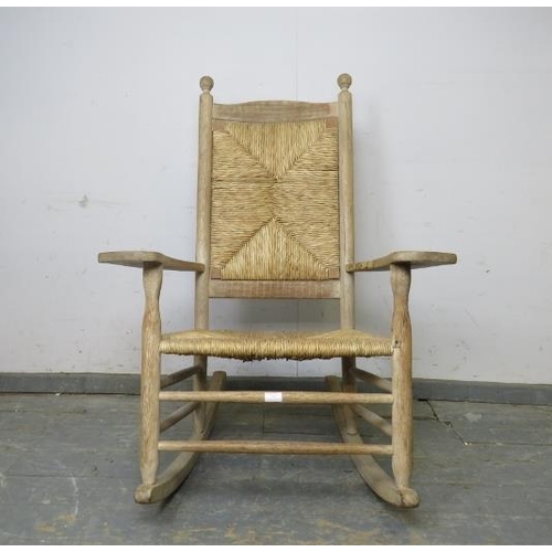 796 - A 19th century light oak and beech rocking chair, with ball finials above a rush seat and backrest, ... 