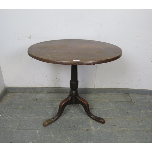 799 - A Georgian mahogany circular tilt-top supper table, on a plain column with splayed tripod supports.
... 