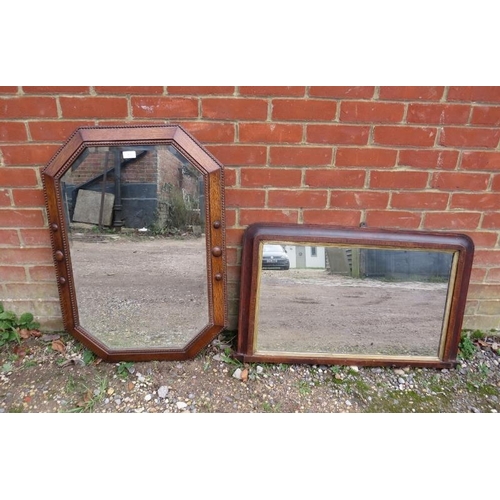 817 - An antique octagonal wall mirror, within an oak surround with beaded edging and roundel decoration. ... 