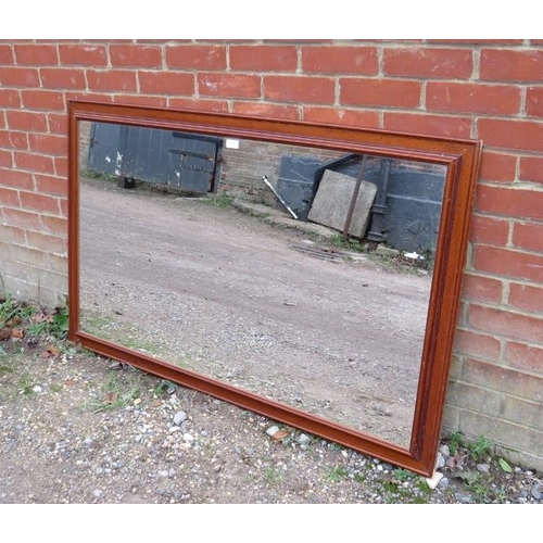 818 - A large rectangular wall mirror within a moulded wooden surround. H85cm W135cm D6cm approx.
Conditio... 