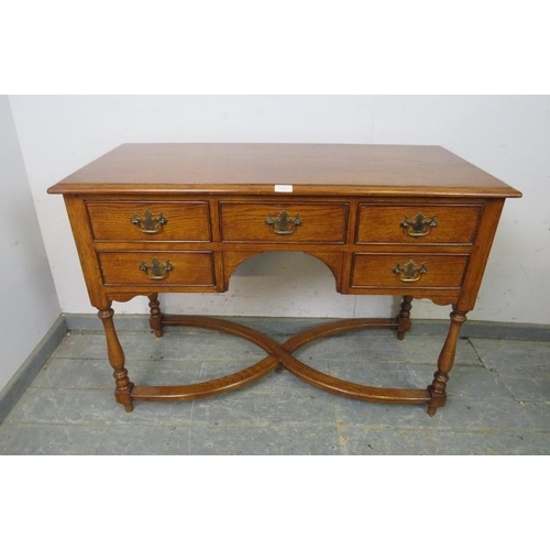 821 - A good quality antique style oak desk in the manner of Titchmarsh & Goodwin, housing five oak lined ... 