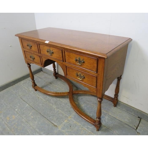 821 - A good quality antique style oak desk in the manner of Titchmarsh & Goodwin, housing five oak lined ... 