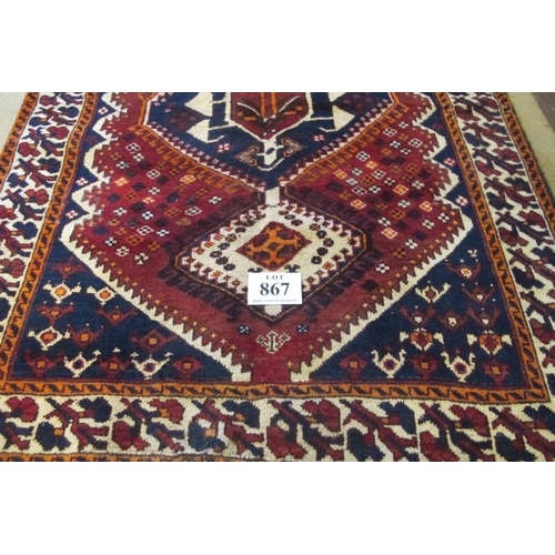 867 - South West Persian Lori Rug.  Three linked central motifs, blue on red ground and with deep patterne... 