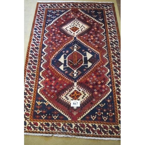 867 - South West Persian Lori Rug.  Three linked central motifs, blue on red ground and with deep patterne... 