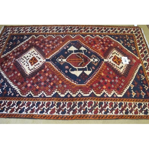 867 - South West Persian Lori Rug.  Three linked central motifs, blue on red ground and with deep patterne... 