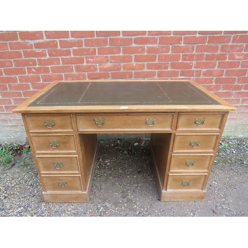 807 - An antique pine kneehole desk, the top with inset gilt tooled green leather surface, housing nine gr... 