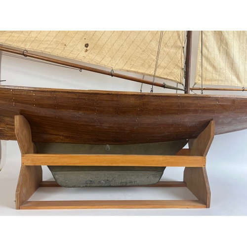 79 - A large vintage model sailing yacht, early 20th century. 181 cm height on stand, 162 cm length.
Cond... 