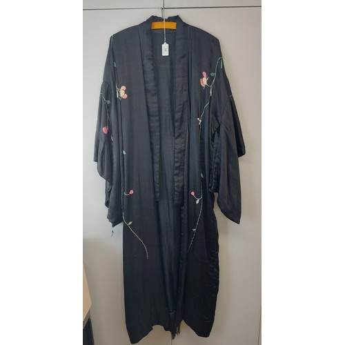 140 - A Chinese silk embroidered black robe, circa 1920s/30s. 137 cm length.
Condition report: Some age re... 